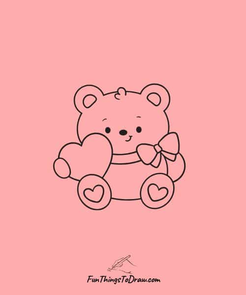 Teddy bear holding heart-wrapped teddy bear