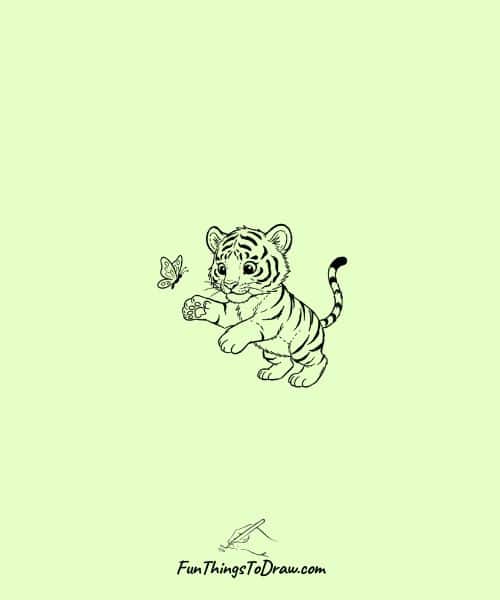 Tiger cub playing with a butterfly