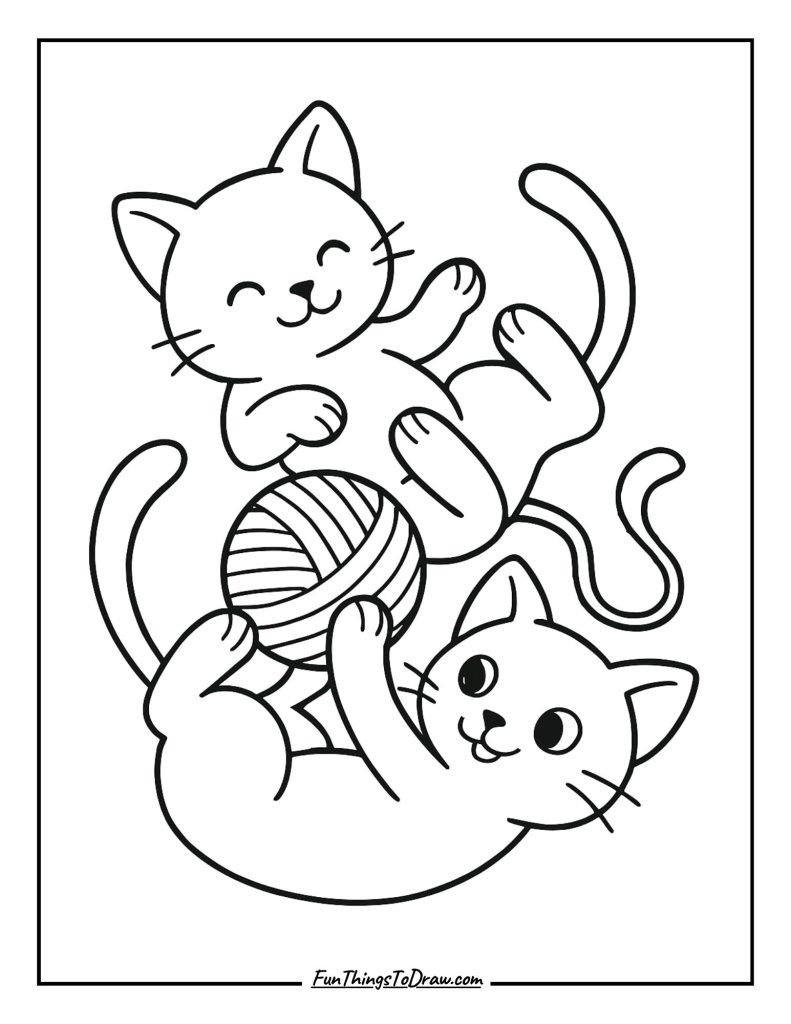 Playful cats tumbling together with a ball of yarn
